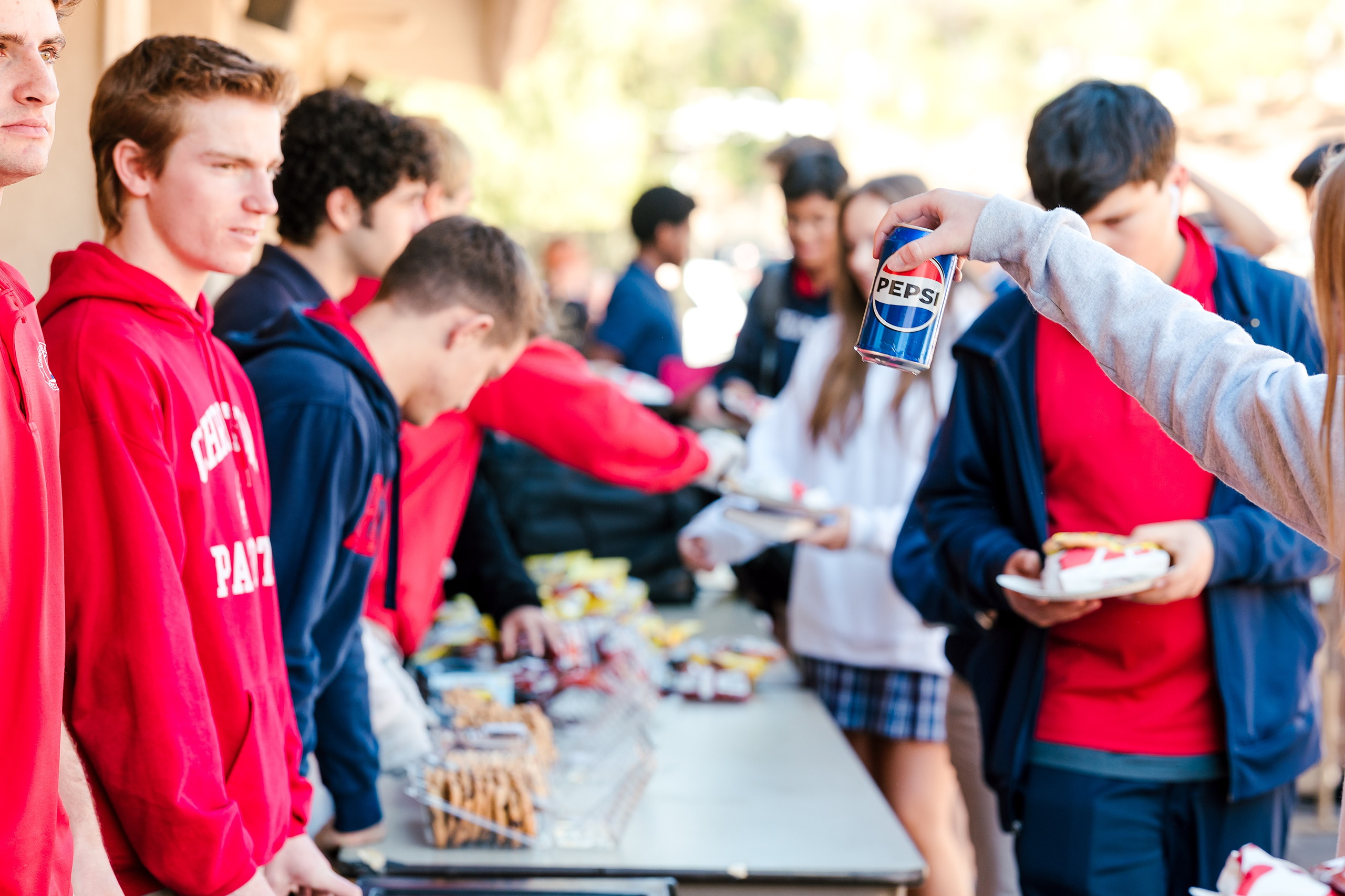 Spiritual Emphasis Week 2025 — 17 Teens get food and drinks at outdoor missions lunch event outdoors
