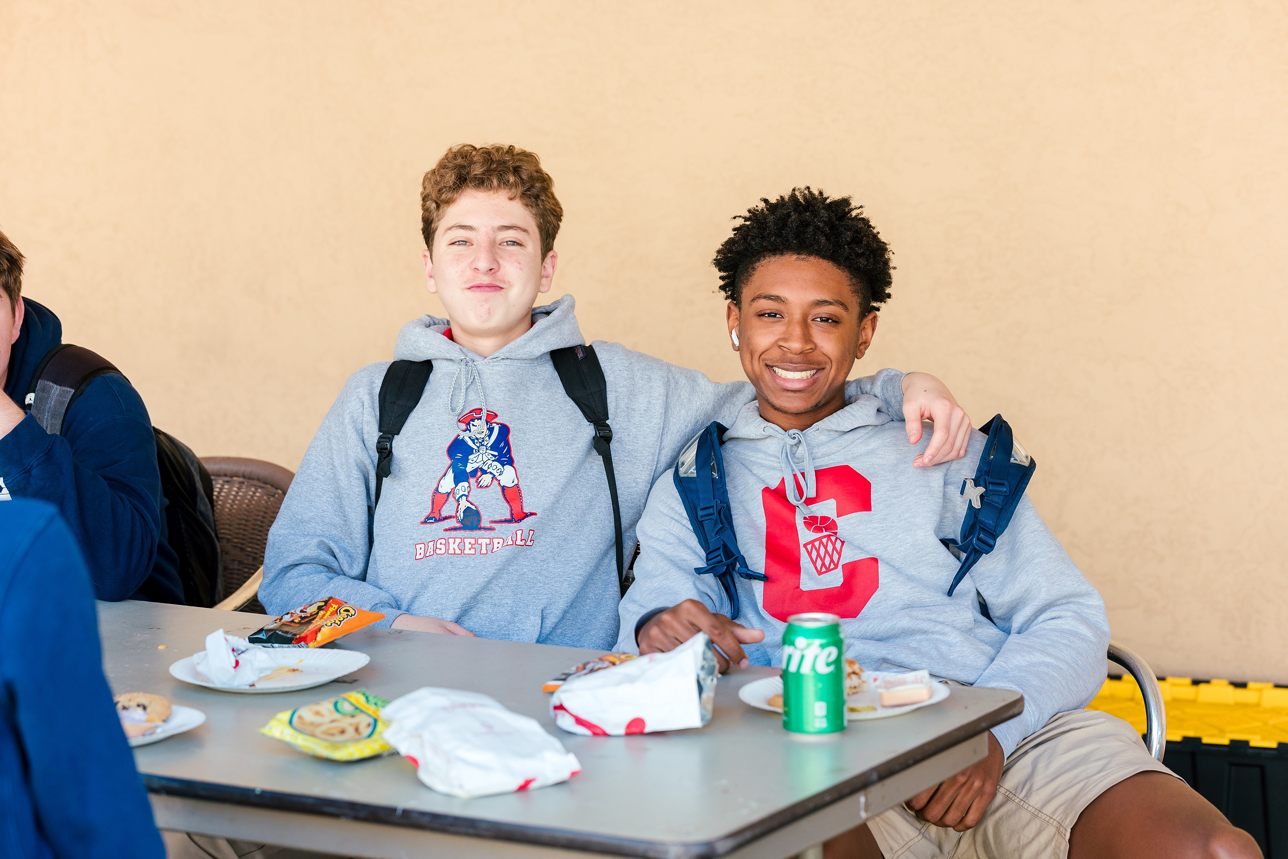 Spiritual Emphasis Week 2025 — 18 Two male students with plates and drinks at missions lunch gathering
