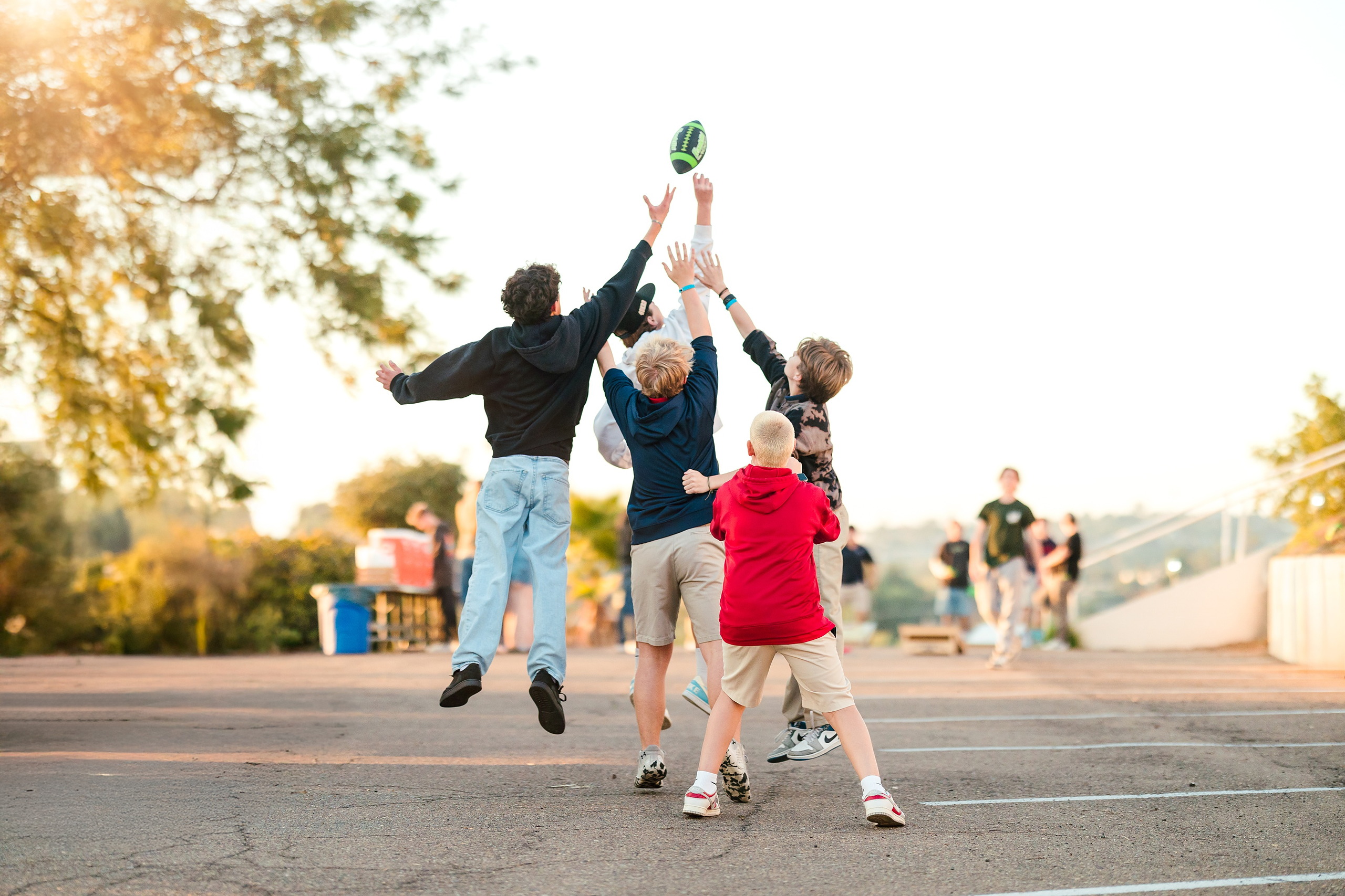 Spiritual Emphasis Week 2025 — 19 Teens play ultimate frisbee in field at golden hour outdoors