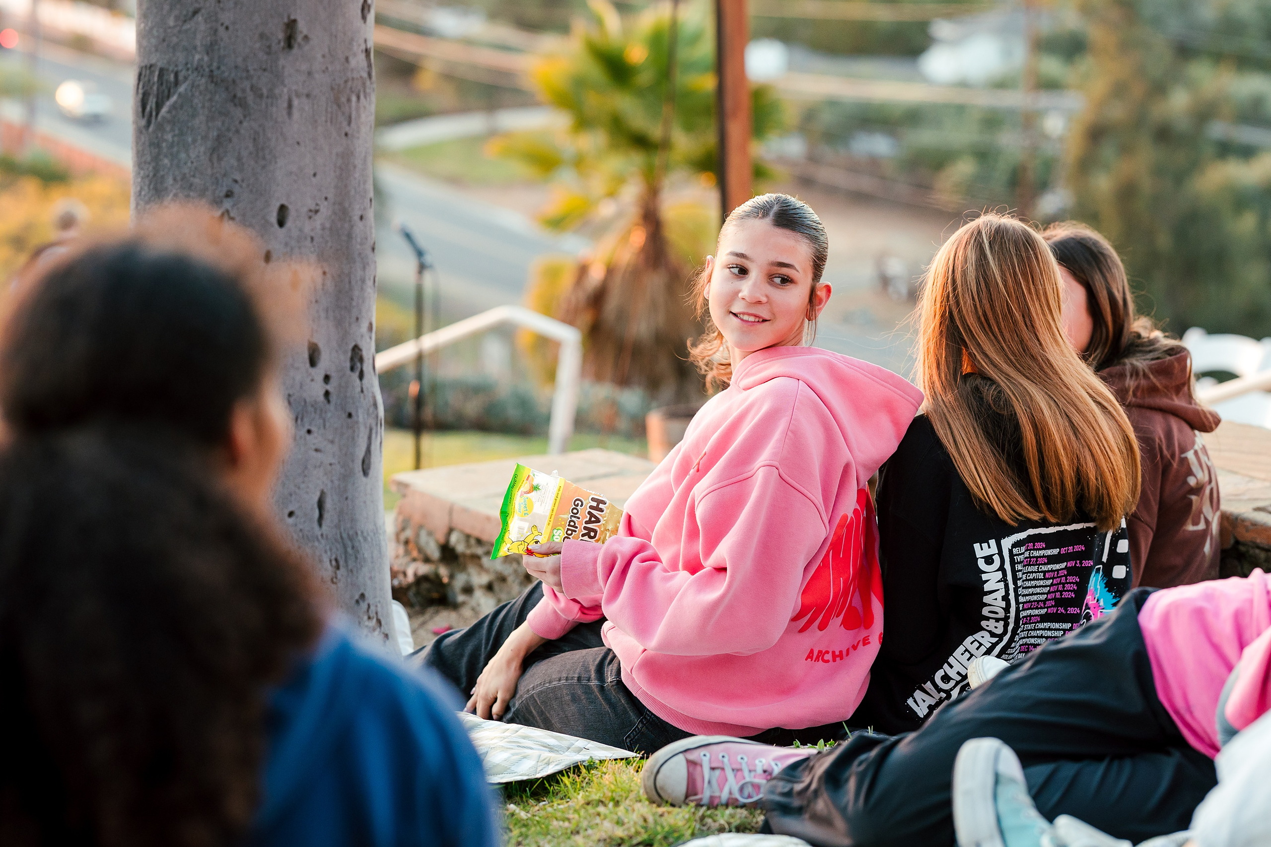Spiritual Emphasis Week 2025 — 22 Students sit together on grass during outdoor event gathering