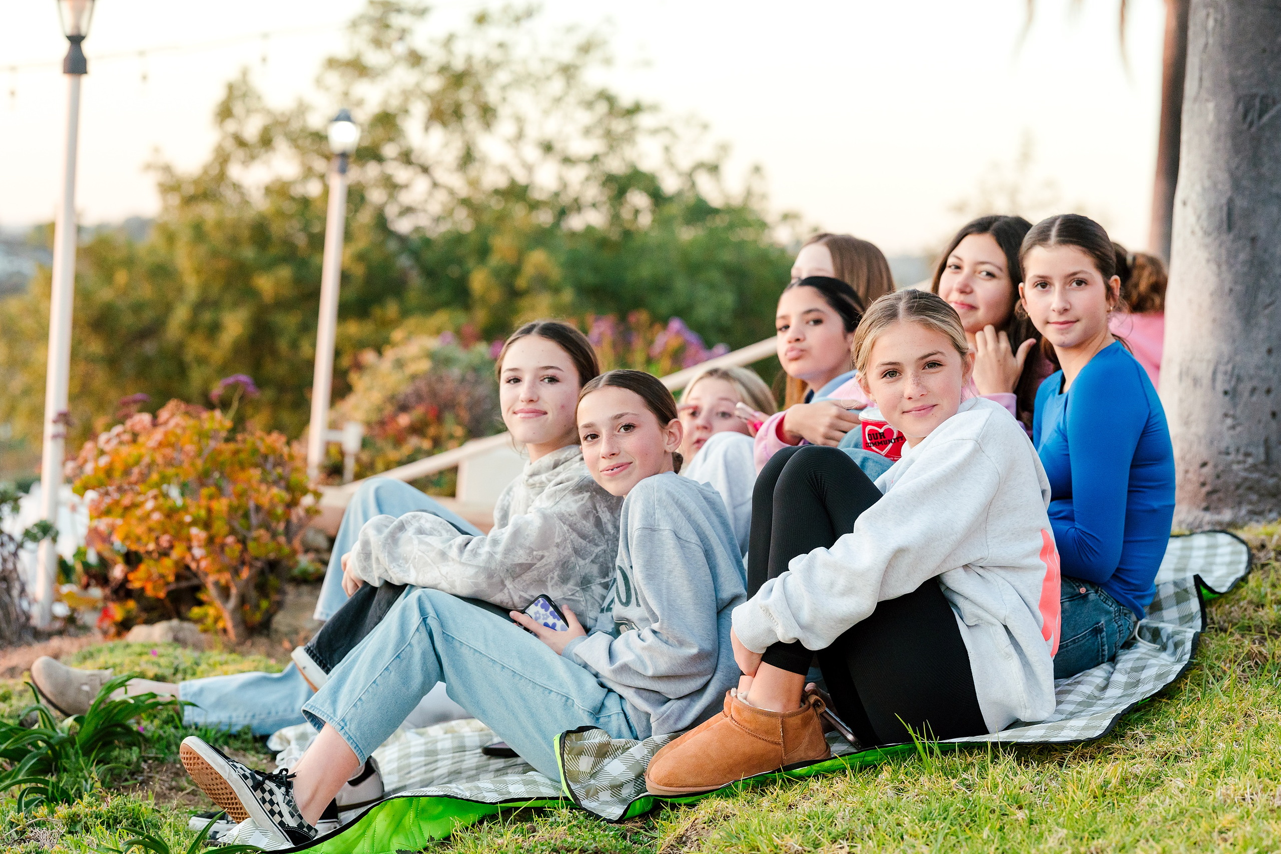 Spiritual Emphasis Week 2025 — 23 Group of female students sit together on blanket at outdoor event
