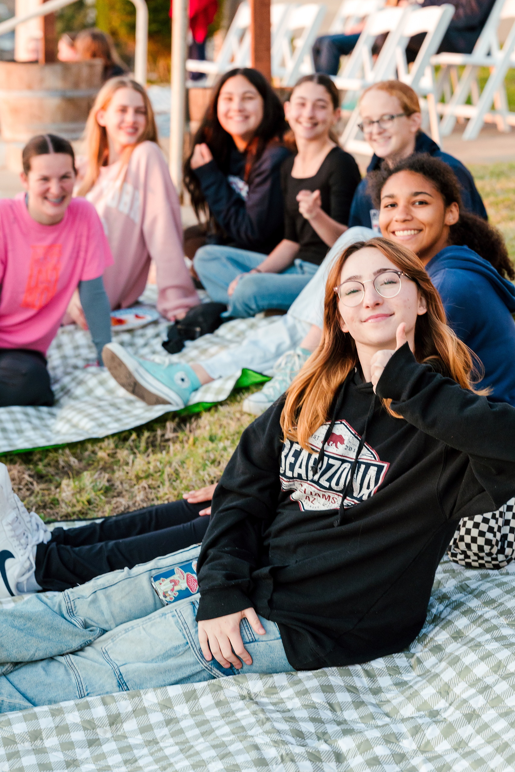 Spiritual Emphasis Week 2025 — 25 Three teen boys eat snacks together at outdoor event gathering