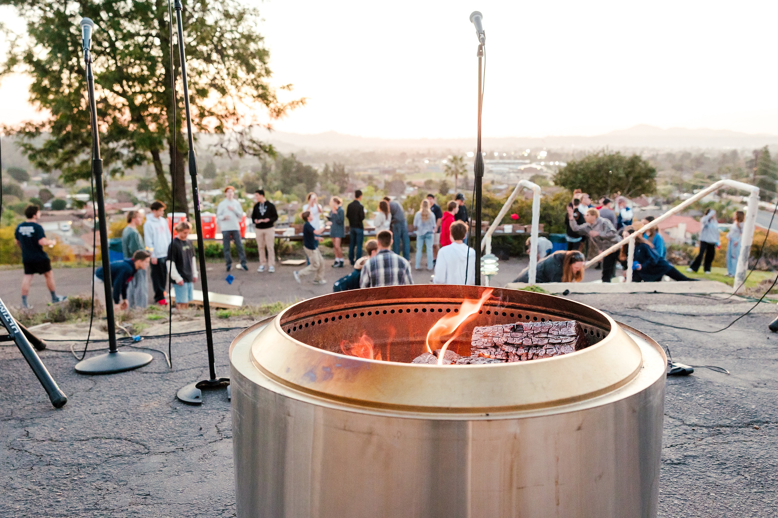 Spiritual Emphasis Week 2025 — 32 Fire pit glows as students gather around during outdoor worship event