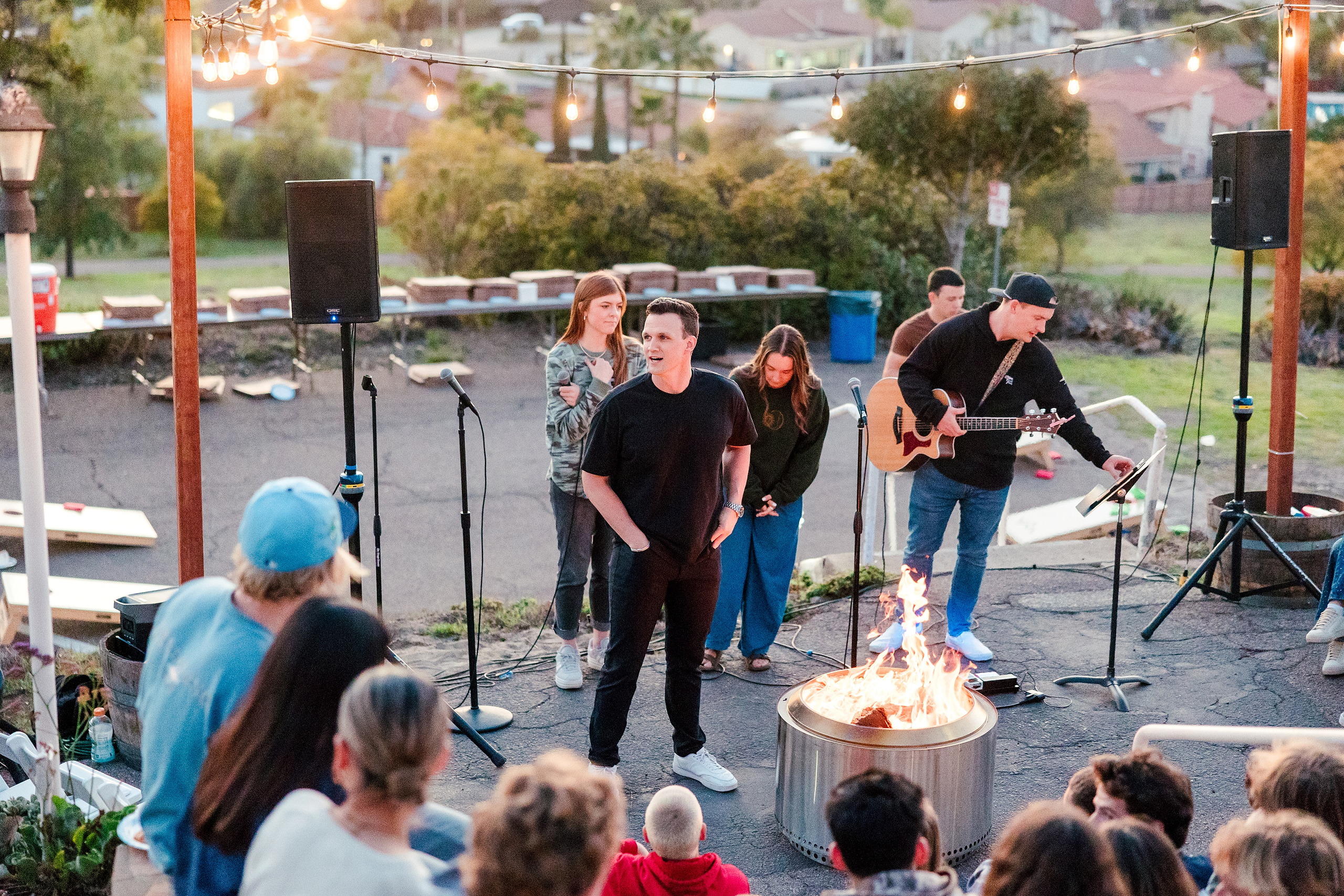 Spiritual Emphasis Week 2025 — 34 Musicians with guitar perform for gathered students around fire pit