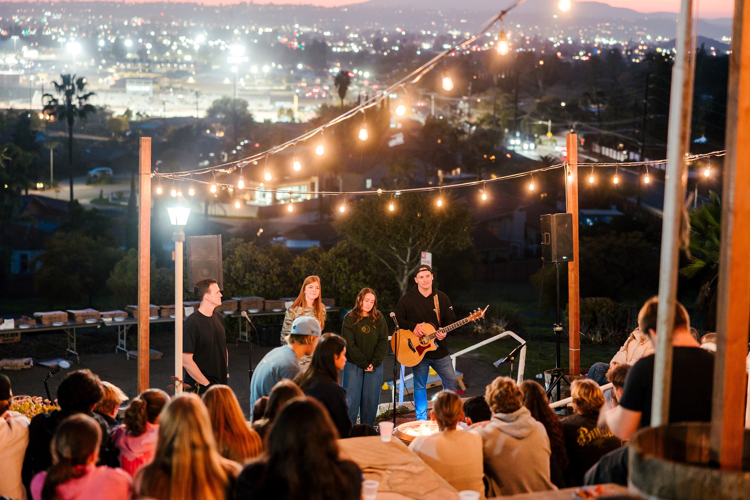 Spiritual Emphasis Week 2025 — 45 High school students raise hands during evening outdoor worship