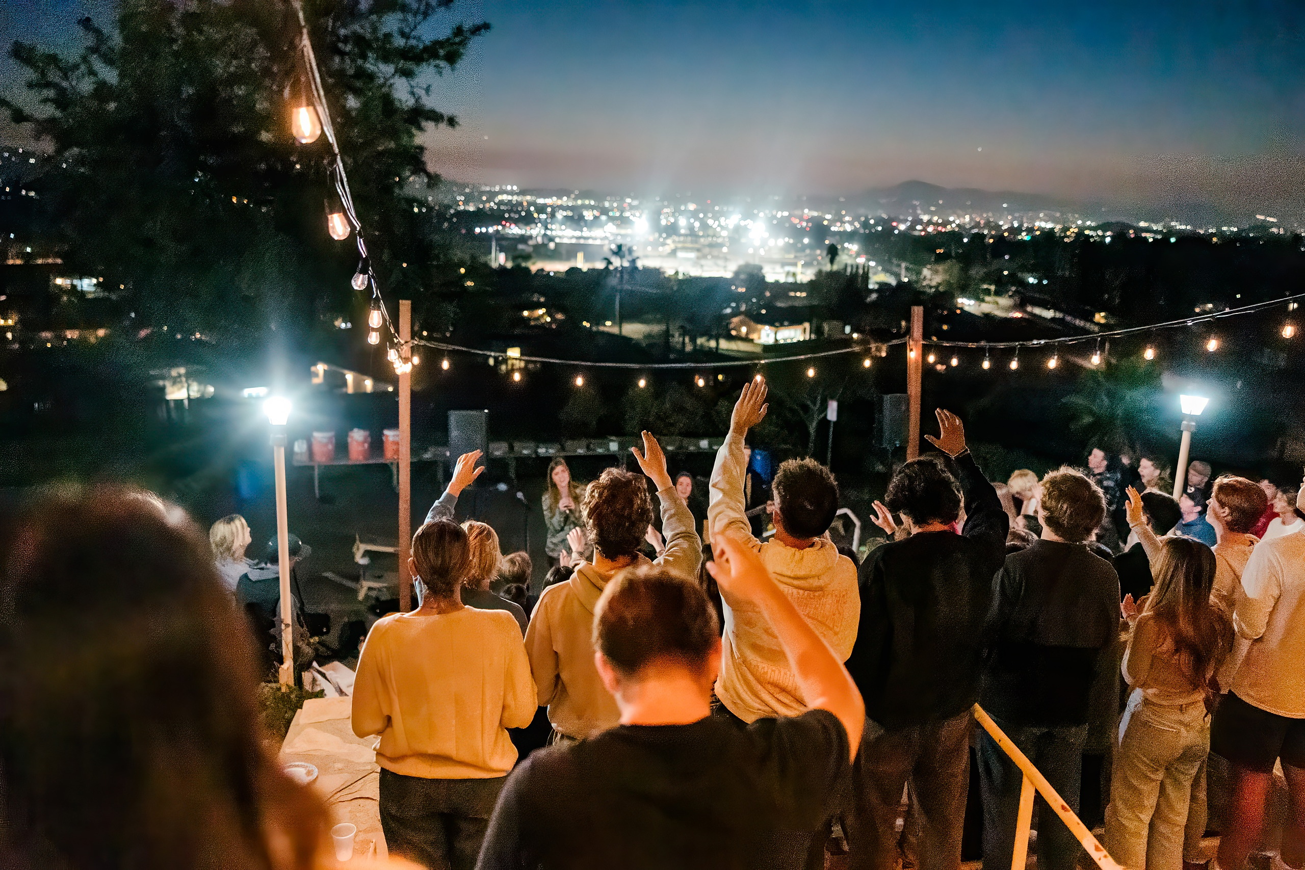 Spiritual Emphasis Week 2025 — 47 Group of students standing close together at outdoor evening worship