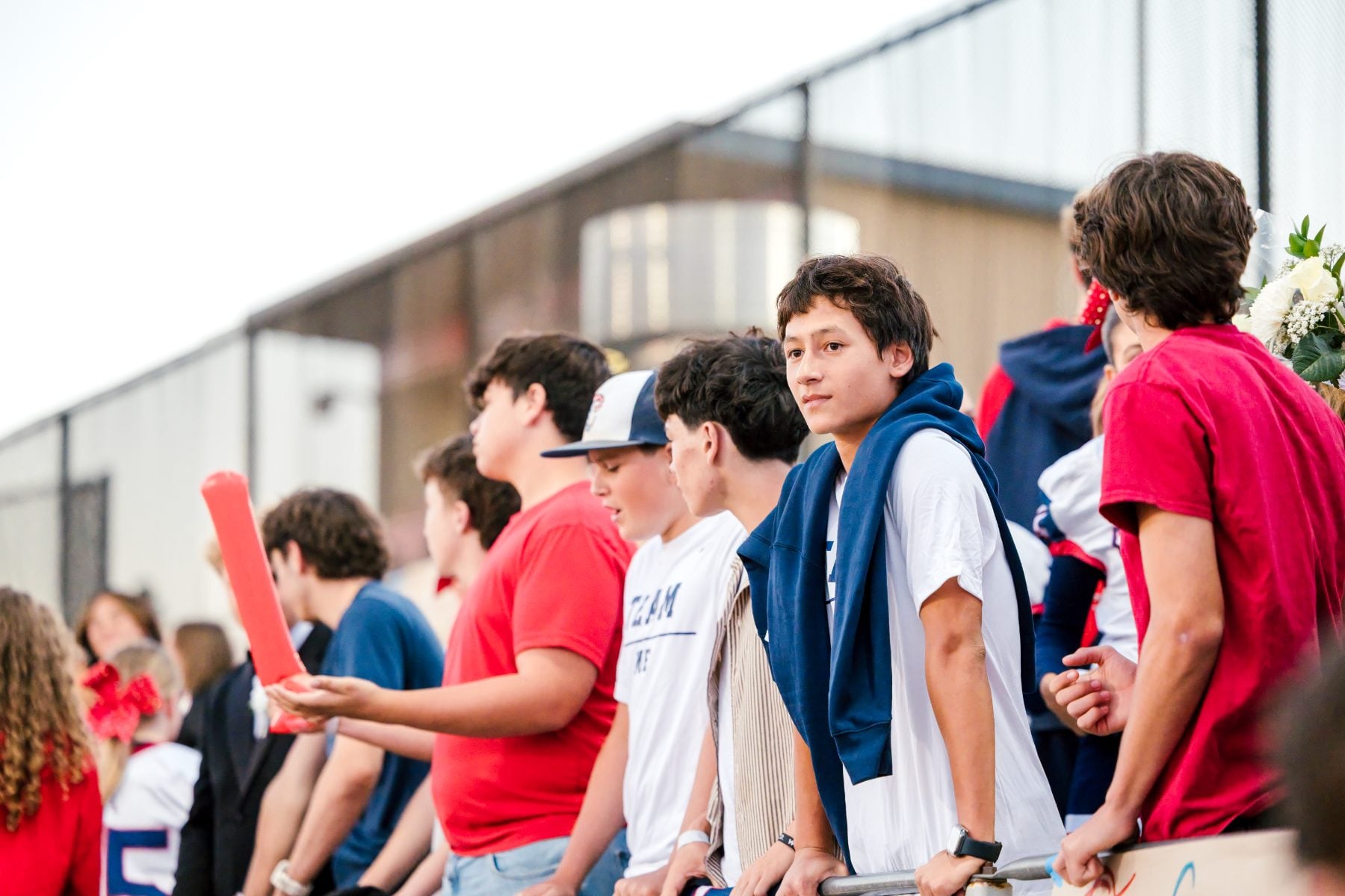 Students gather trackside cheering during the Patriots homecoming game